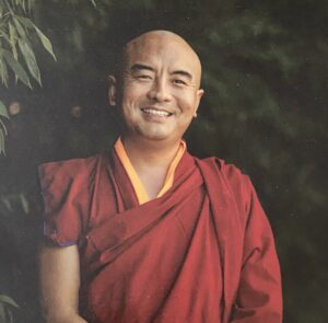 An image of a smiling Minguyr Rinpoche